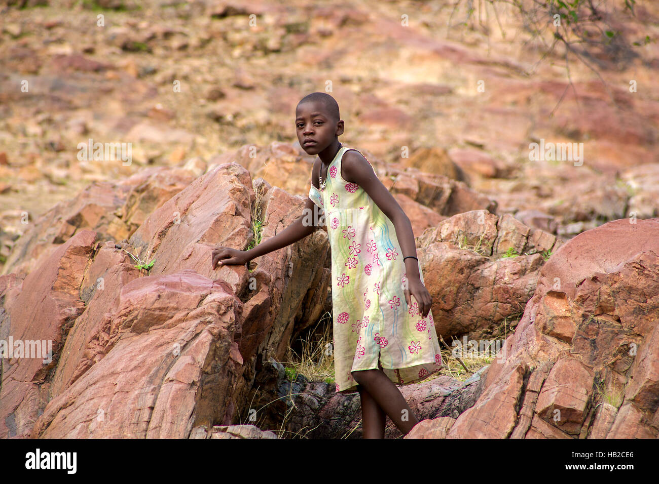 Young Himba posing in front of the camera at Epupa Falls in Namibia Stock Photo