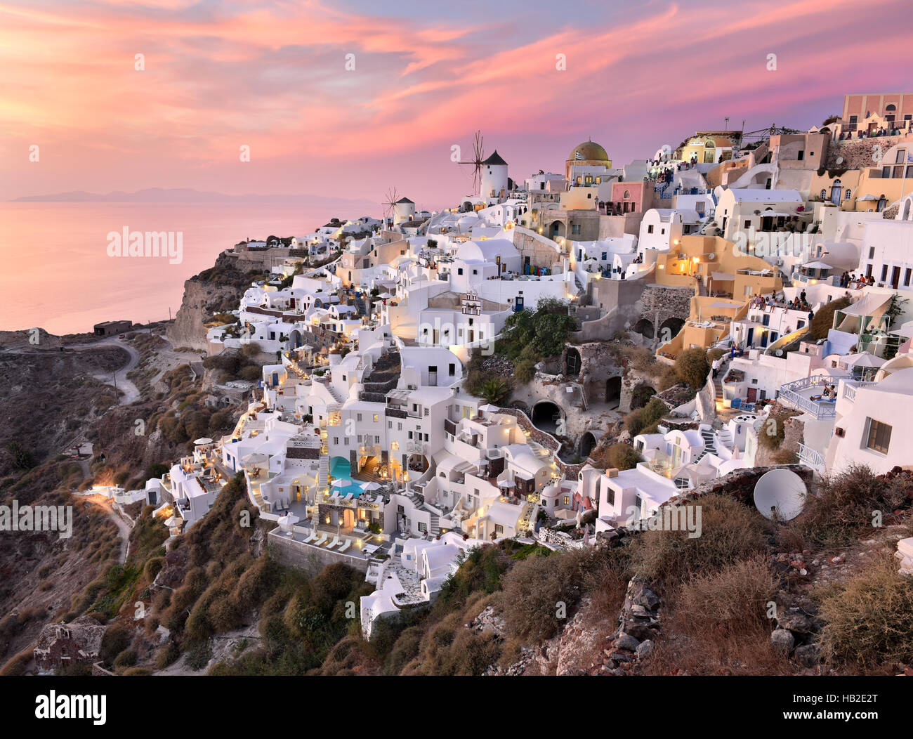 Oia Village in Cycladic Architecture style in Santorini, Greece during a pink sunset. Stock Photo