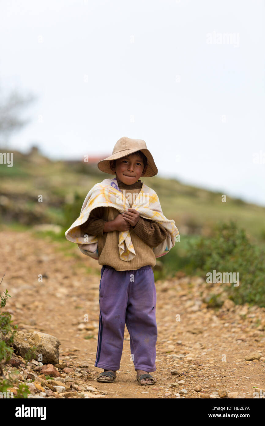 MOON ISLAND, BOLIVIA, JANUARY 13: Portrait of young small Bolivian boy standing and looking at the camera on Isla del Sol (Moon Island), Copacabana. B Stock Photo