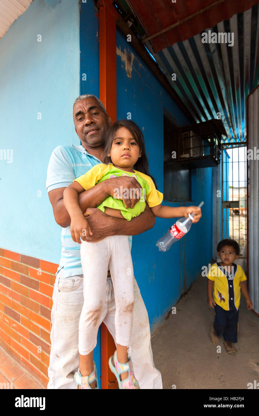 CARACAS, VENEZUELA, MARCH 29: Father and his children in front of his home in slum district in  Caracas. Economical crisis in Venezuela 2015 Stock Photo