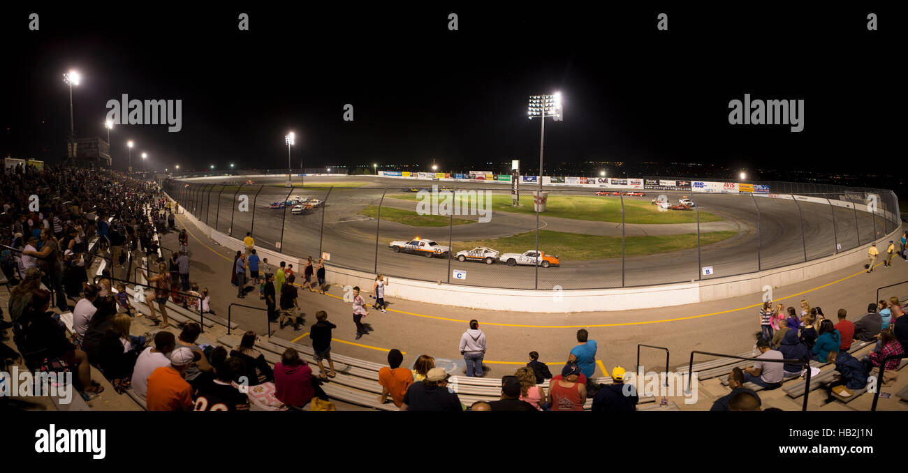 People attending a stock car racing car at night in Salt Lake City Stock Photo