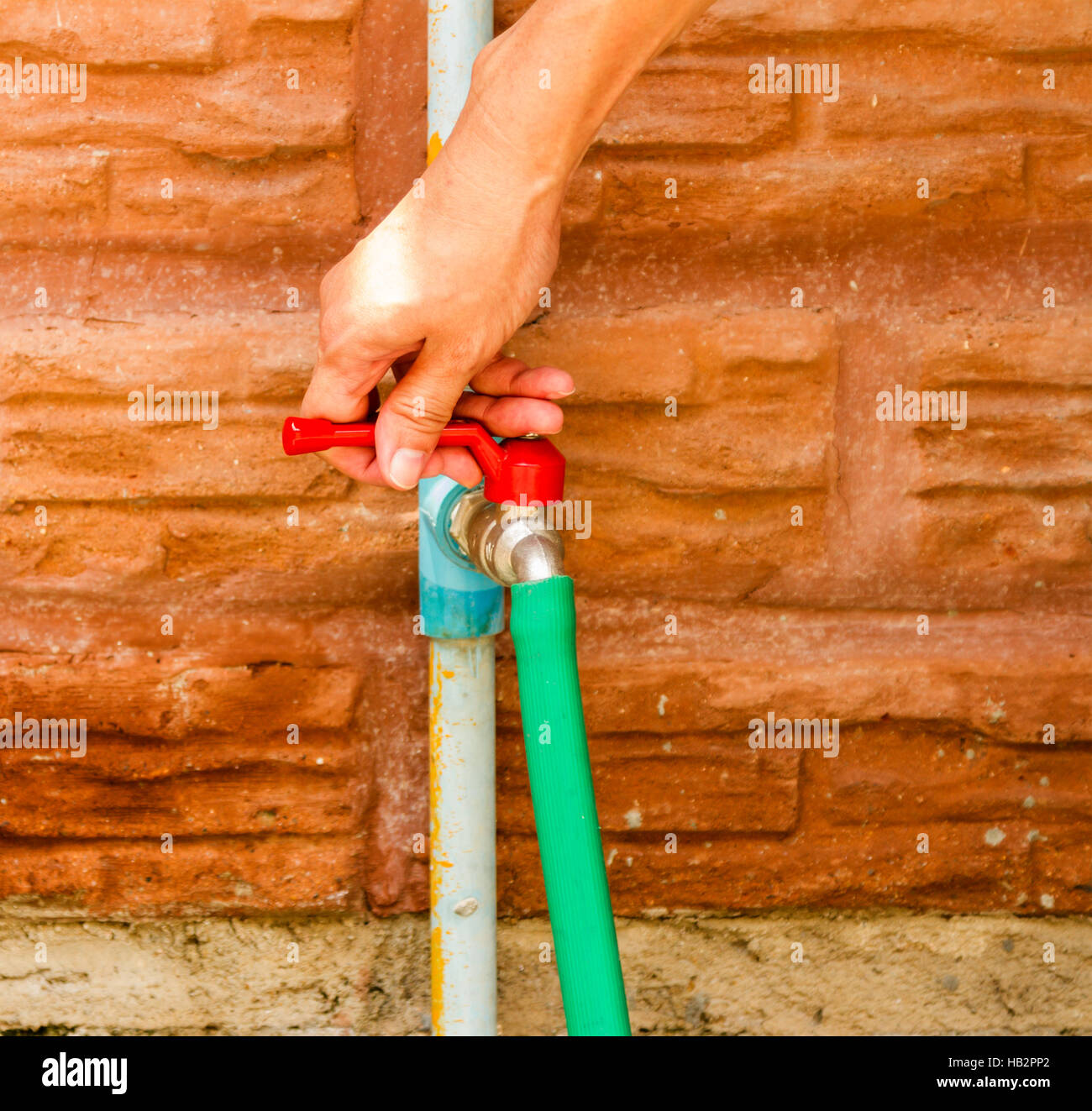Wasting water in the garden on hand. Stock Photo