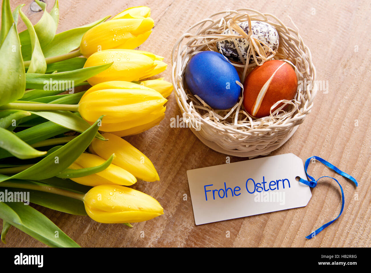 Frohe Ostern card and Easter basket. Stock Photo