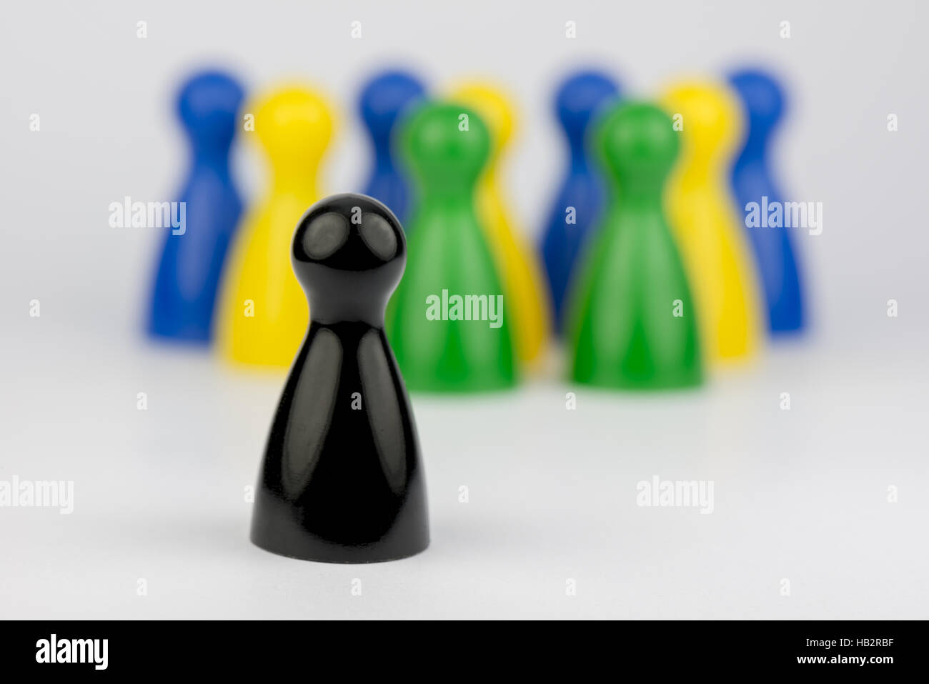 Conceptual game pawns Stock Photo