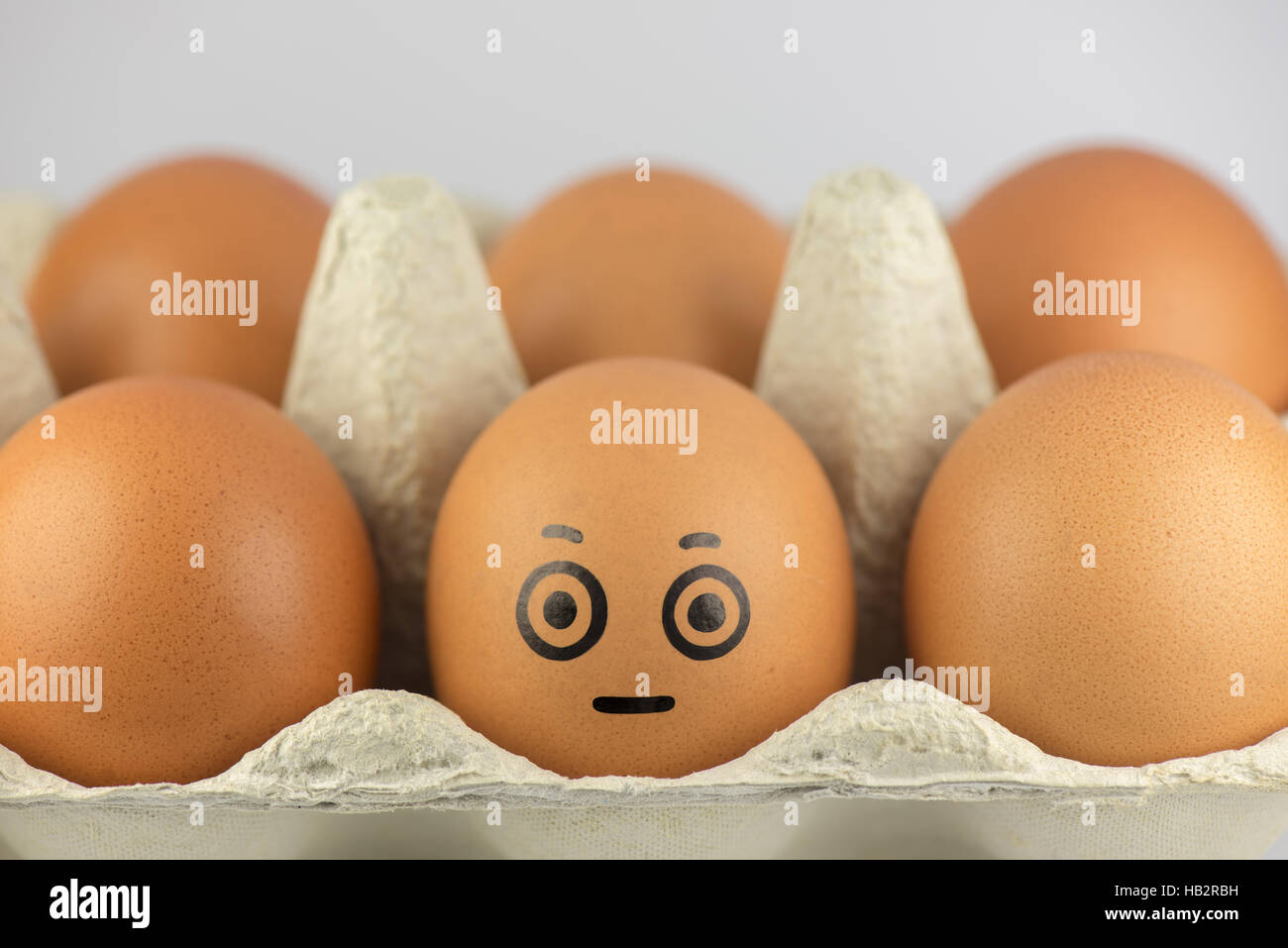 Egg with a face in a egg carton Stock Photo