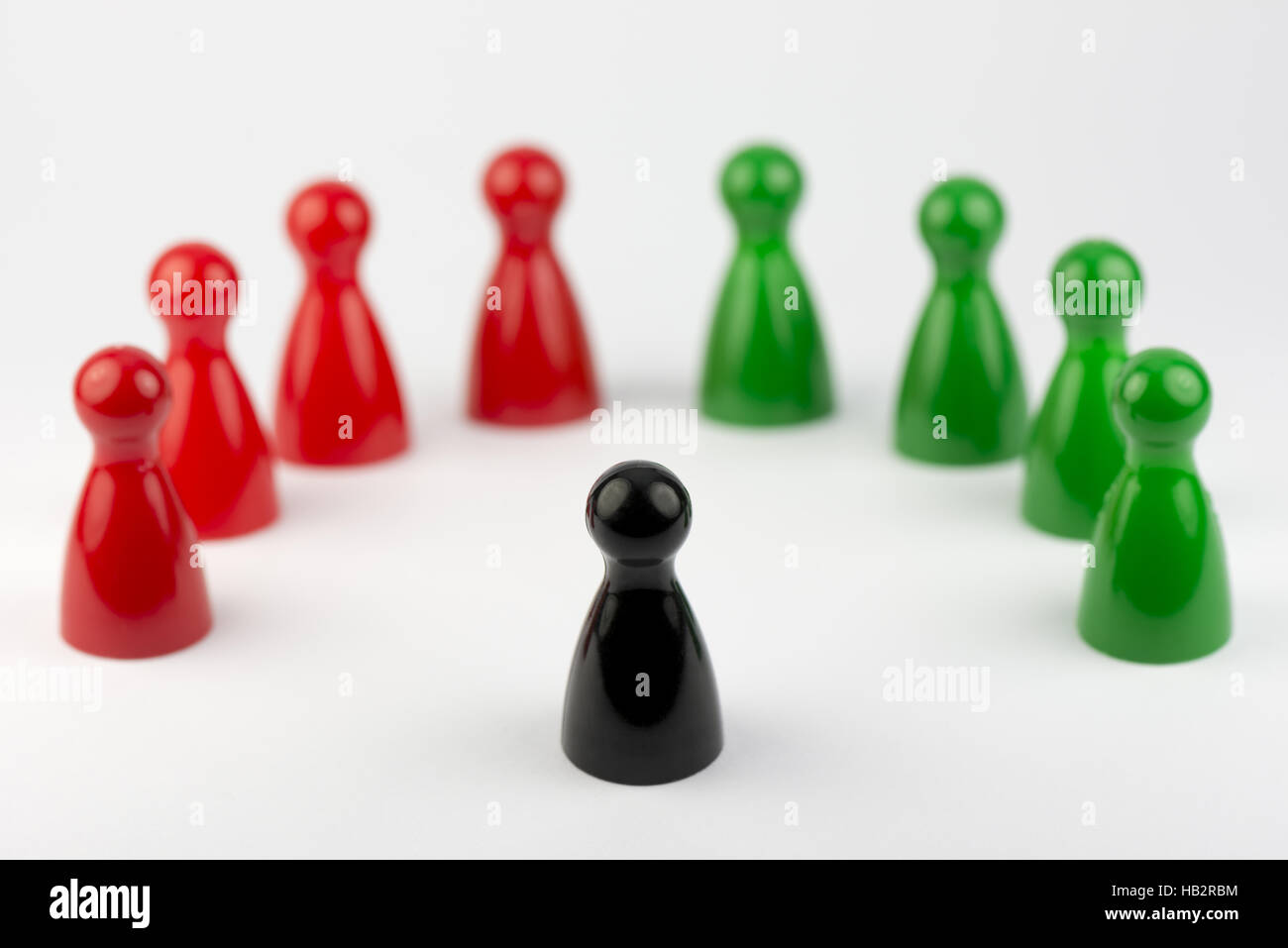 Conceptual game pawns Stock Photo