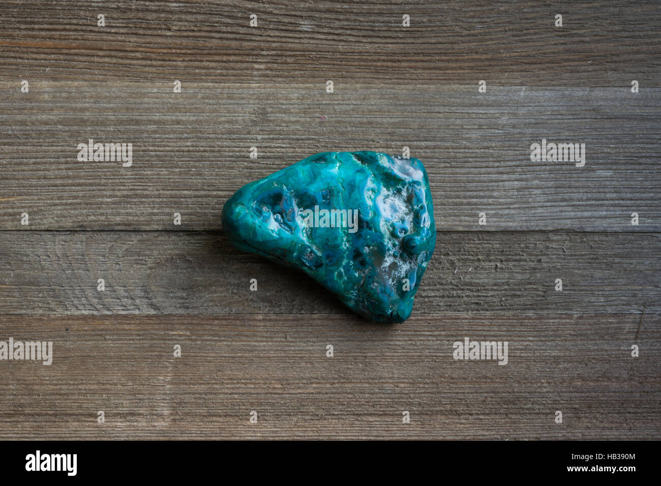 Chrysocolla specimen against wooden backdrop Stock Photo