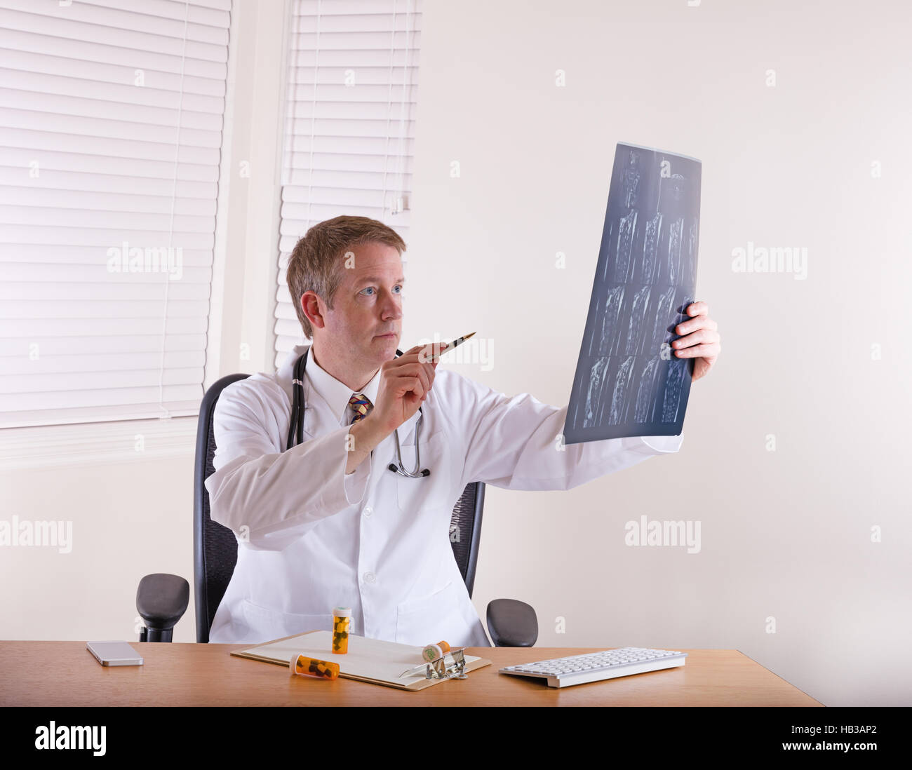 Doctor pointing pen at xray chart Stock Photo Alamy