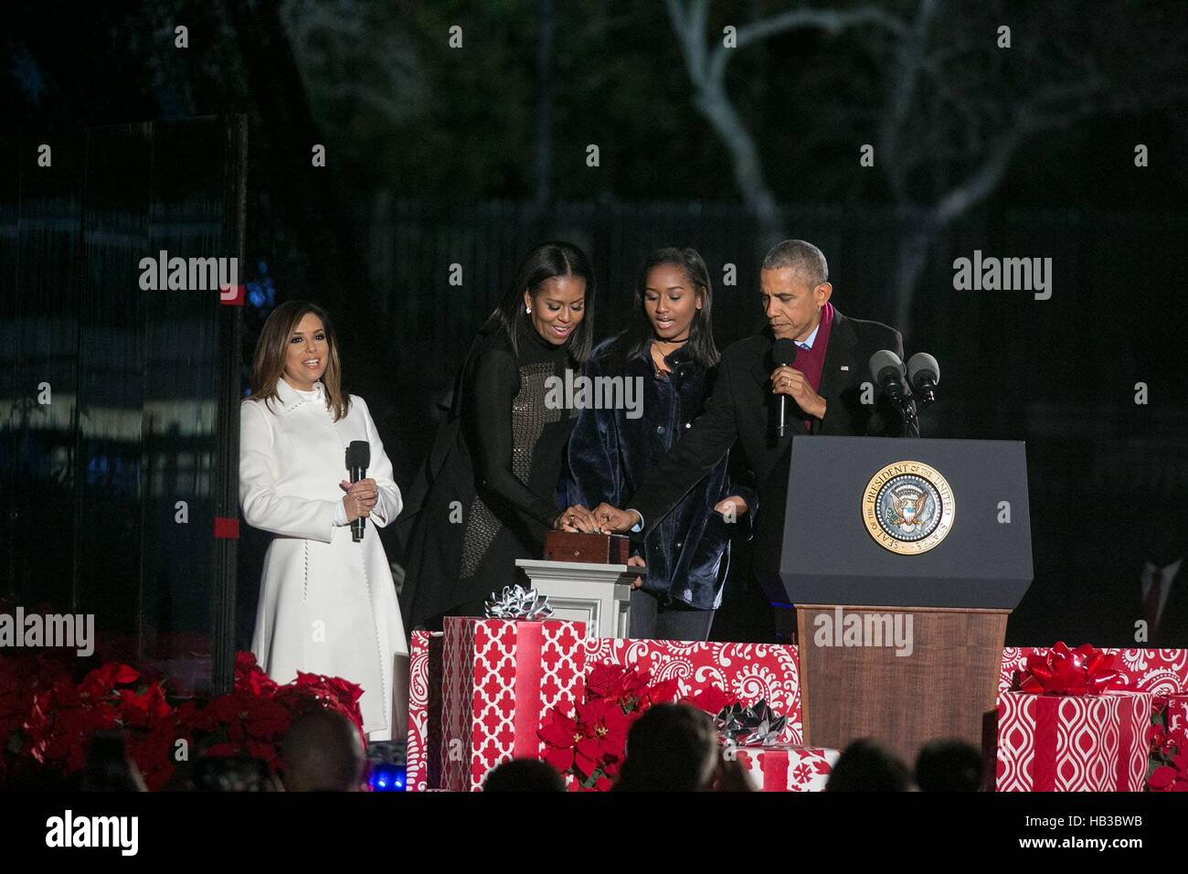 U.S President Barack Obama , First Lady Michelle Obama and daughter Sasha push the button to light the national Christmas tree as host Eva Longoria looks on at the Ellipse December 1, 2016 in Washington, DC. Stock Photo
