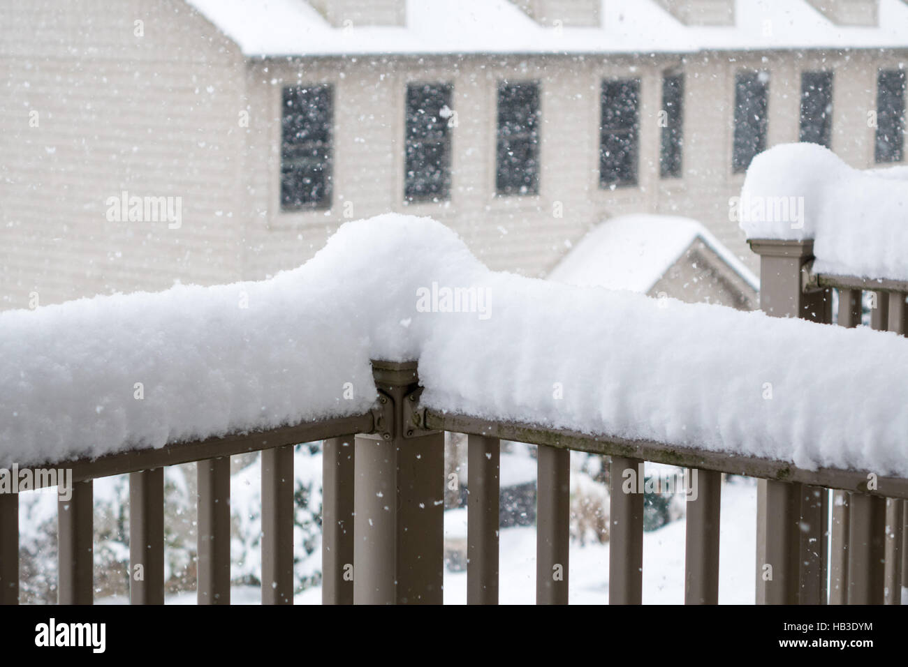 Snow piled high on railing of balcony Stock Photo