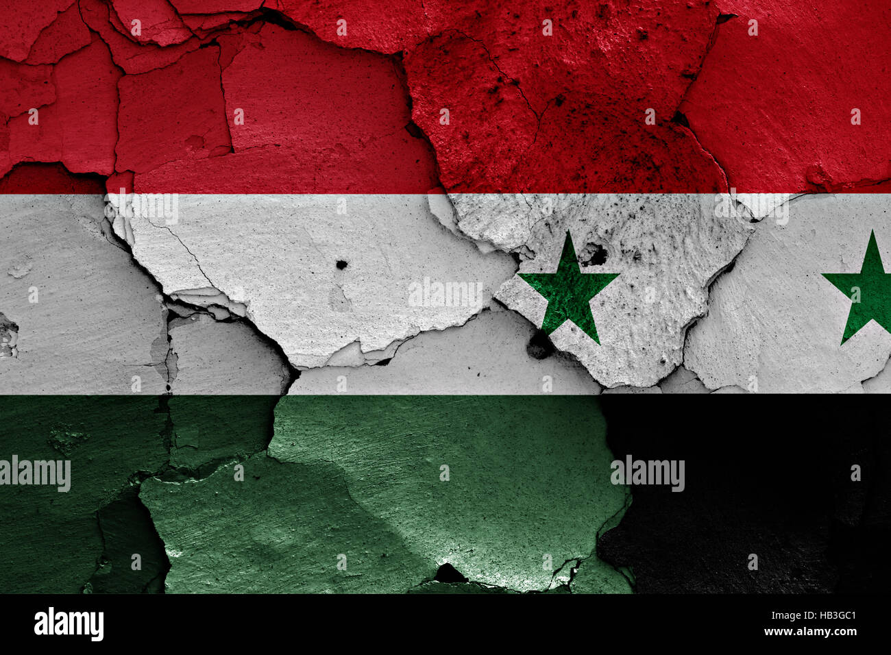 flags of Hungary and Syria painted on cracked wall Stock Photo