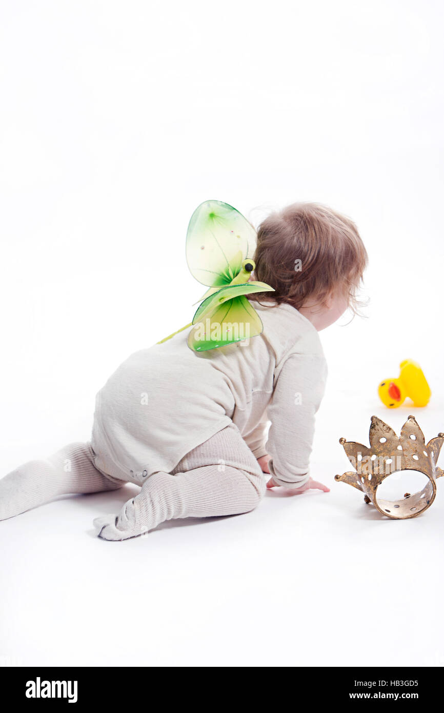 Infant with rubber duck and romper suit Stock Photo