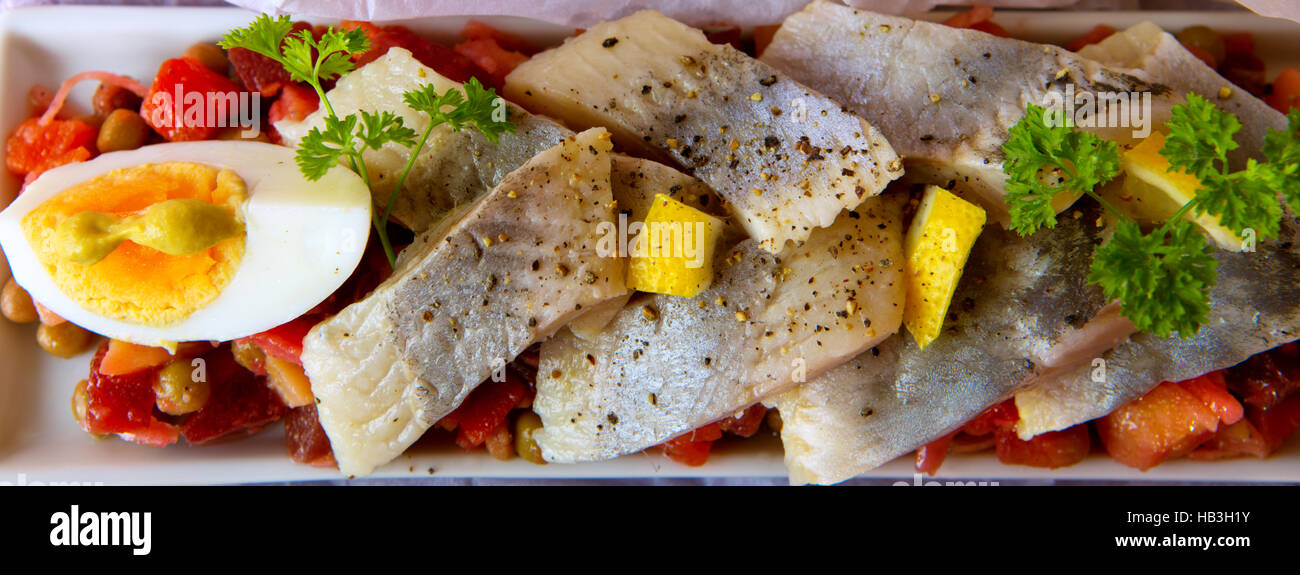 Salted herring with salad on the table. Stock Photo