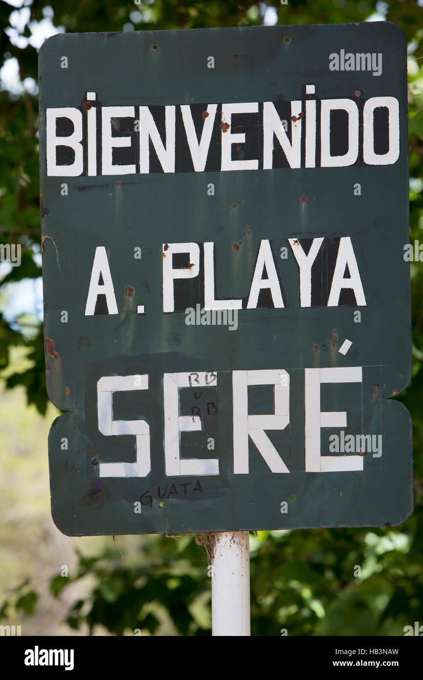 Rusted old retro sign saying welcome to the Beach of Sere written in Spanish with blurred background. Uruguay Stock Photo