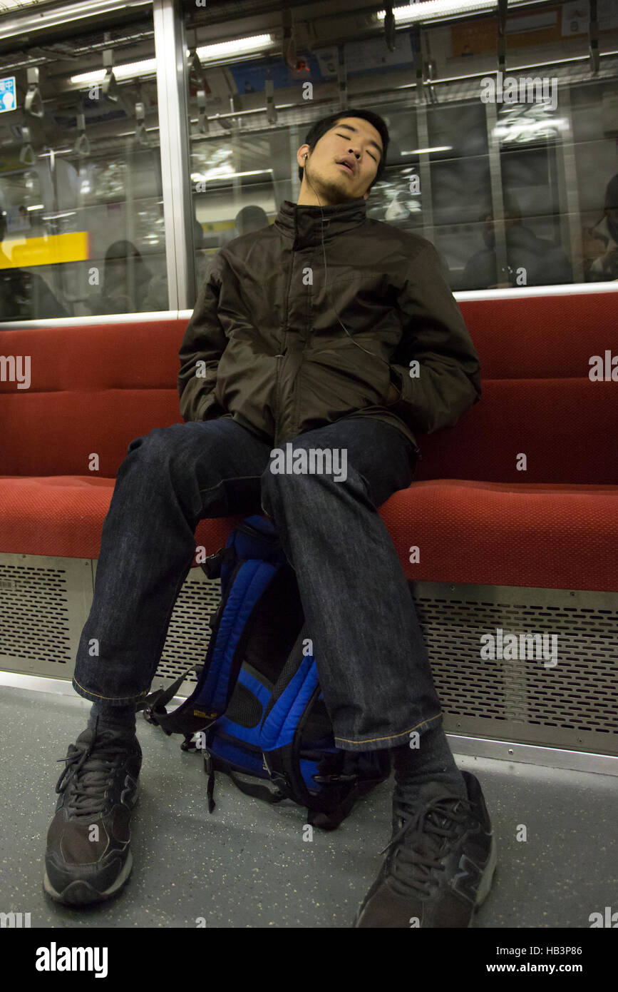 Commuter sleeping in Tokyo metro Stock Photo