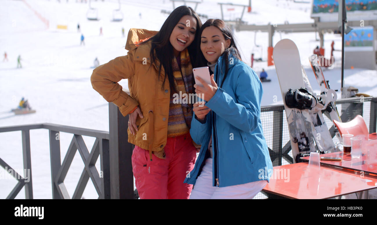Two young woman checking out a selfie Stock Photo - Alamy