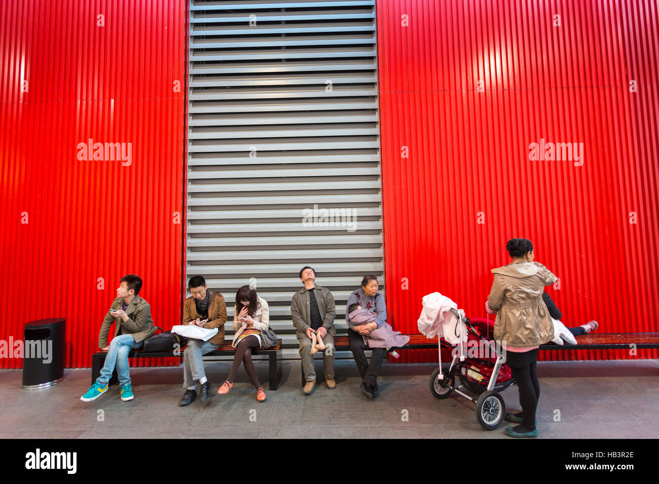 People sitting down on bench at the museum Stock Photo