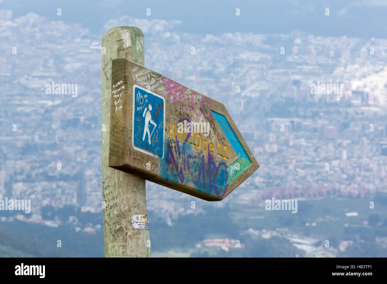 Directional sign post to the Pichincha Volcano, with Quito in the background Stock Photo