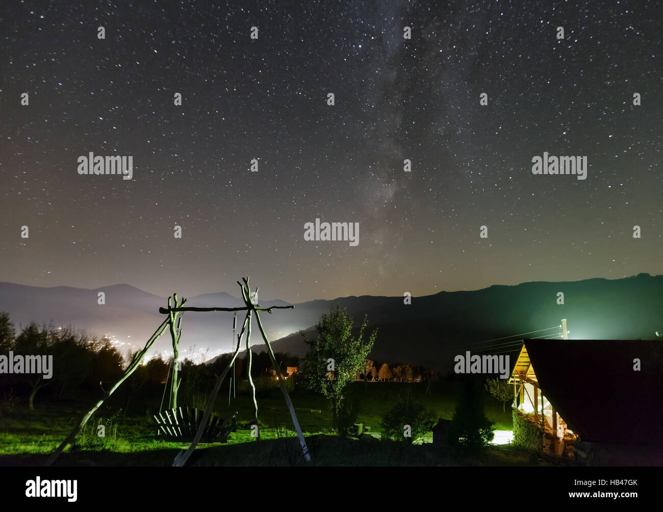 Starry night sky over mountain village Stock Photo - Alamy