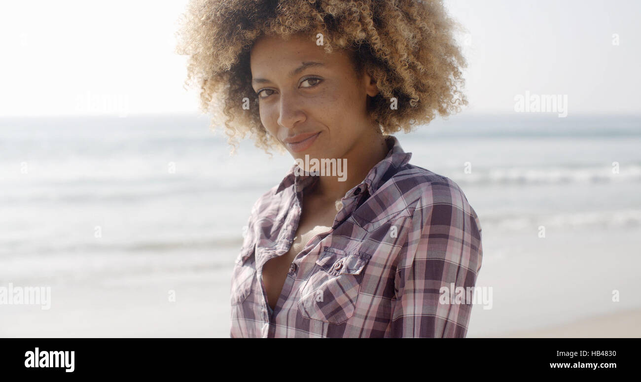 Woman Smiling At Camera On The Beach Stock Photo - Alamy