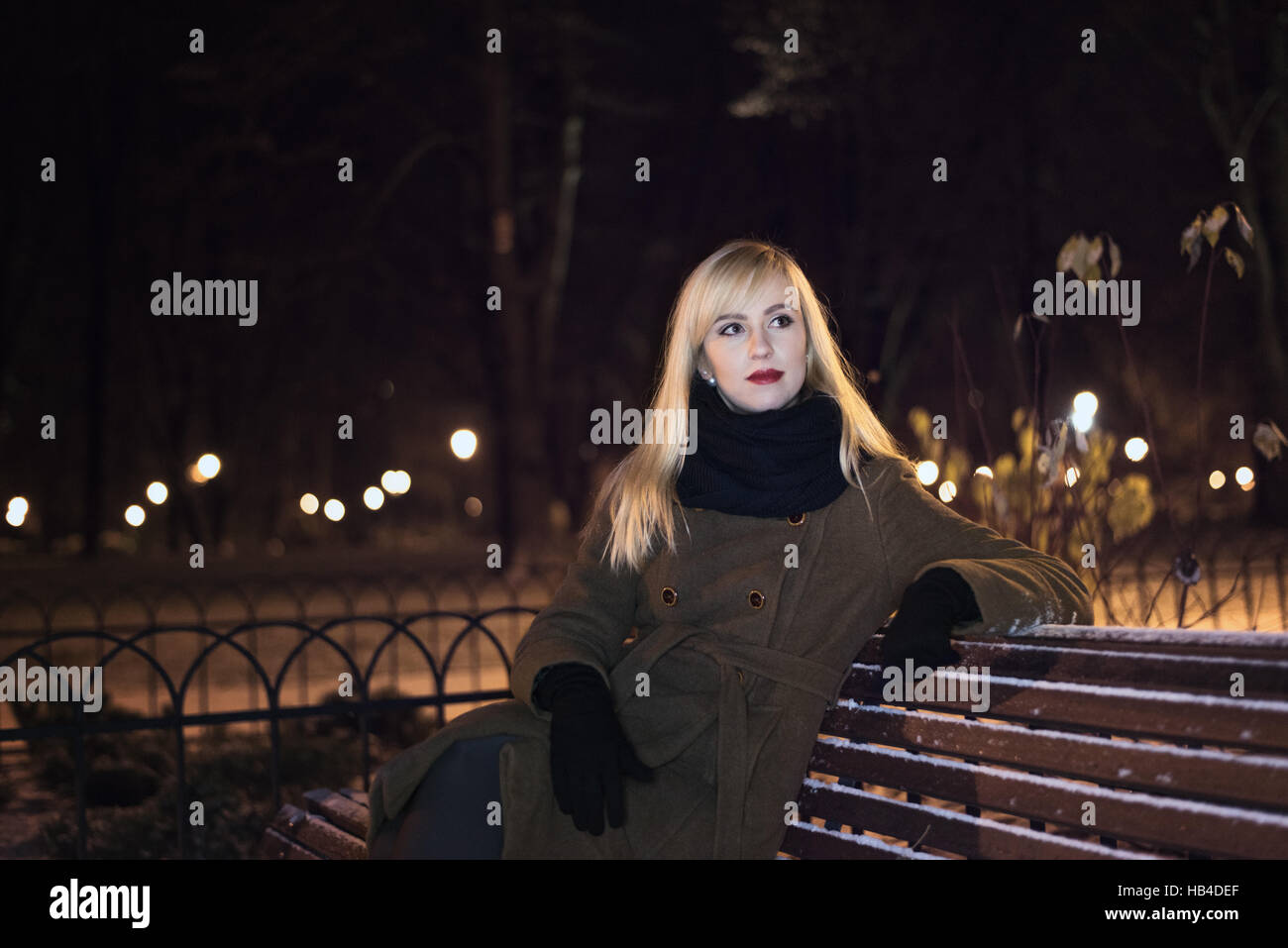 Beautiful woman in the park at night Stock Photo