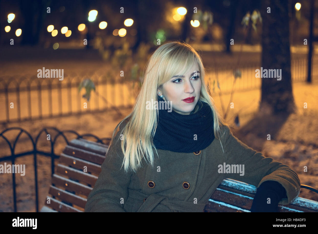 Portrait of woman in park at night Stock Photo