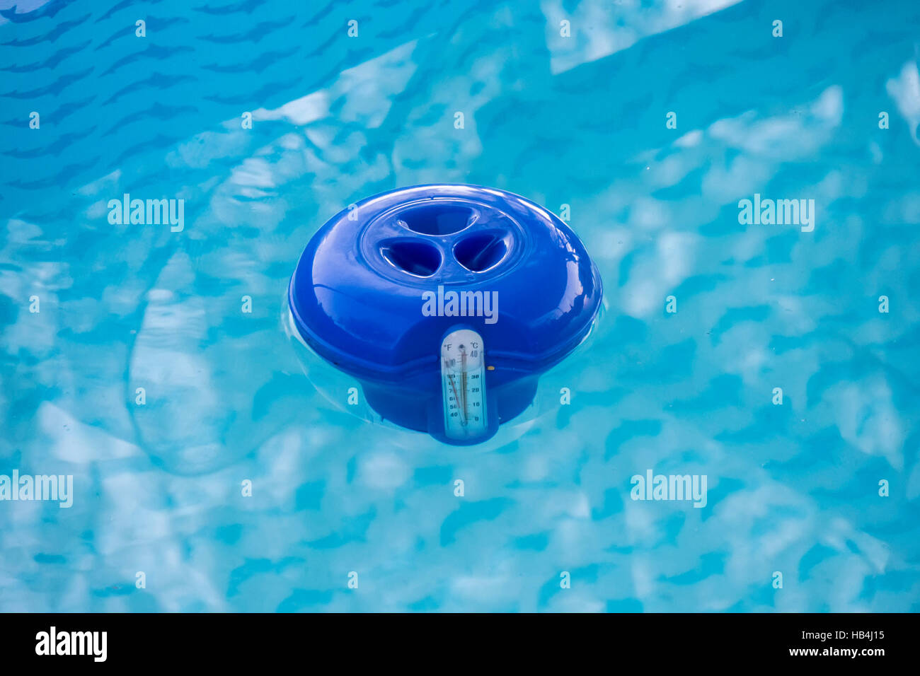 Blue pool chlorine dispenser in the water Stock Photo