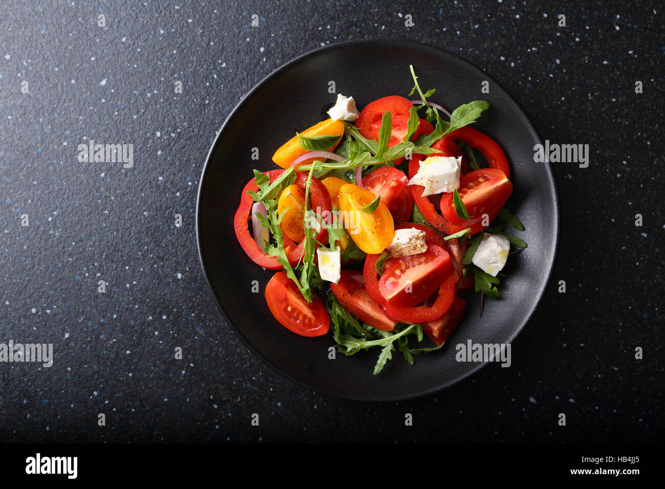 Fresh salad on black plate, food top view Stock Photo Alamy