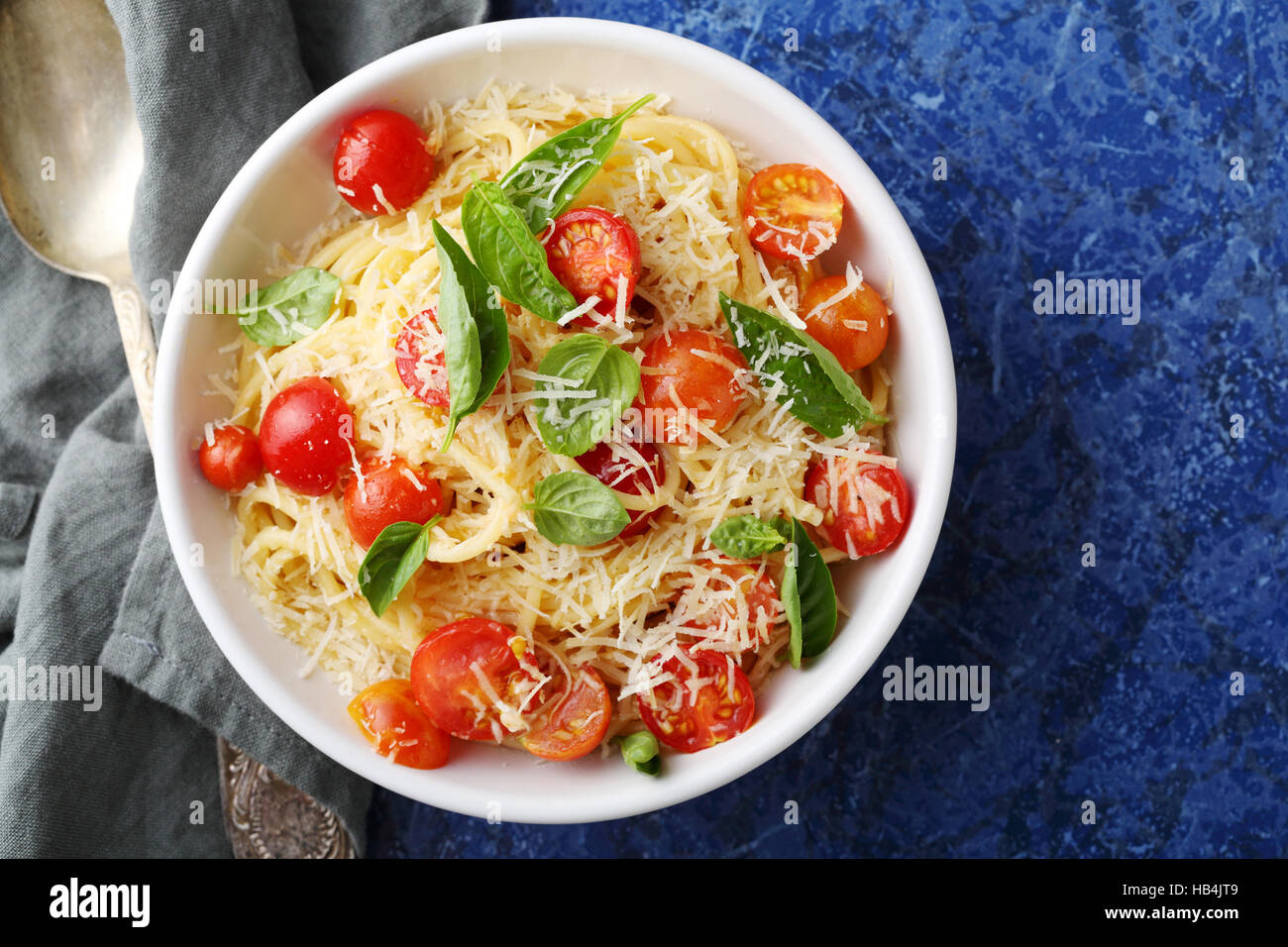 Tasty spaghetti with fresh tomato, food top view Stock Photo
