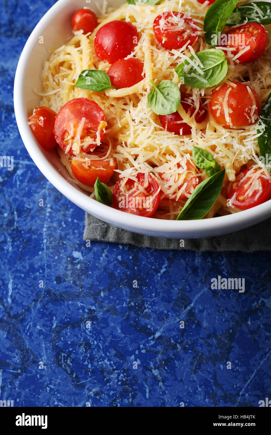 spaghetti with fresh tomato and basil leaves, food closeup Stock Photo