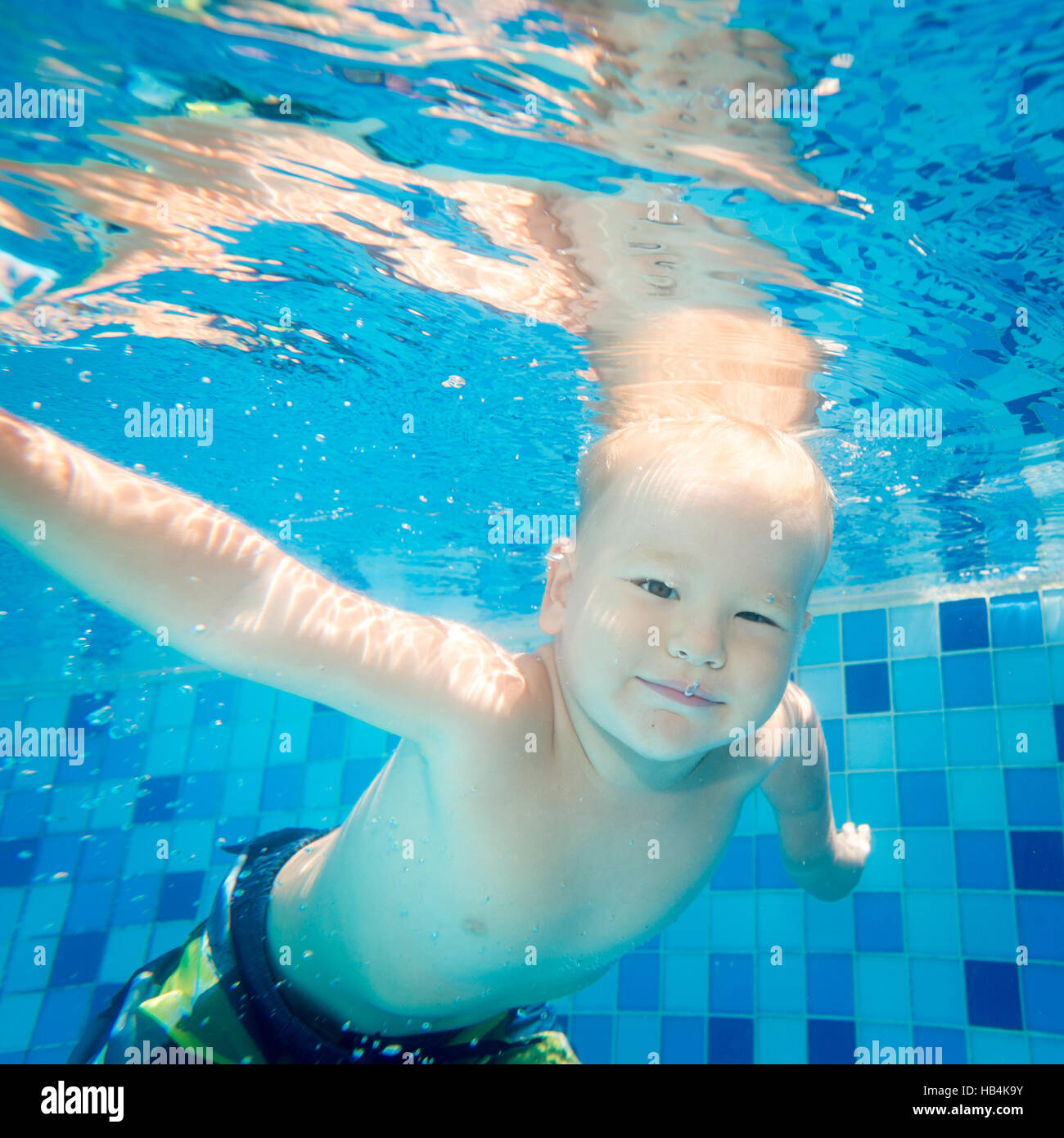 Boy swims underwater Stock Photo