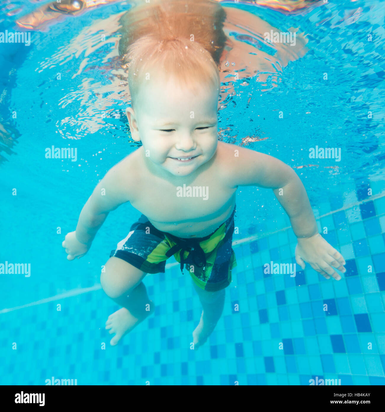 Boy swims underwater Stock Photo