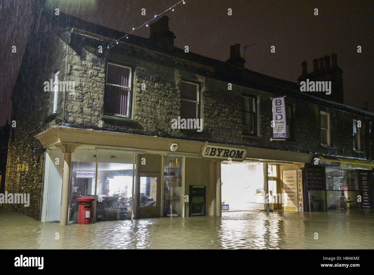 A row of shops and a post box flooded in Kendal, Cumbria in the early hours of the 6th of December 2015 after 36 hours of torrential rain. Stock Photo