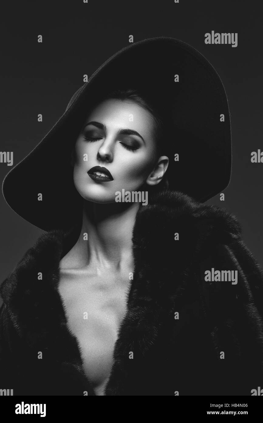 Beautiful girl in fur coat and hat Stock Photo - Alamy