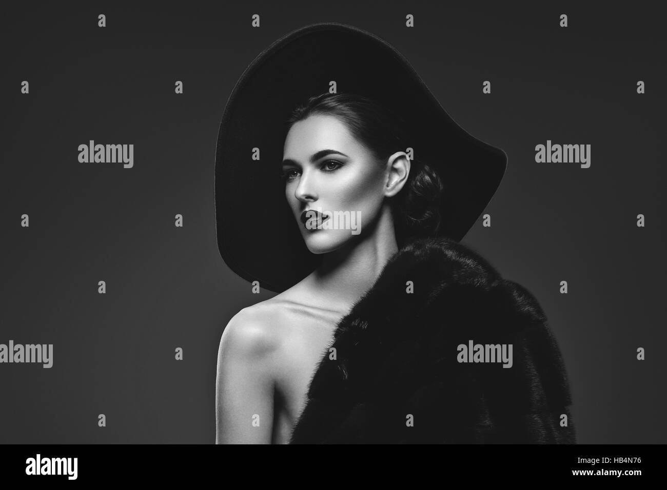 Beautiful girl in fur coat and hat Stock Photo - Alamy