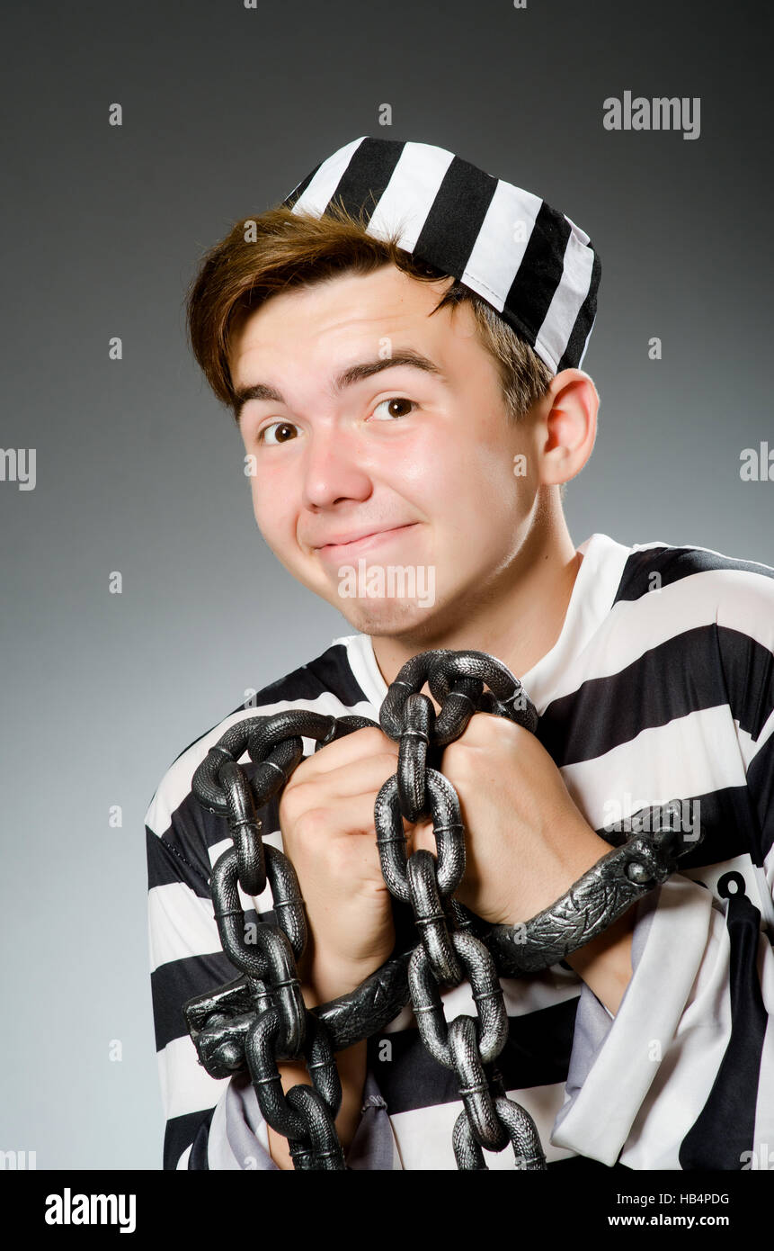 Funny prisoner in prison concept Stock Photo - Alamy