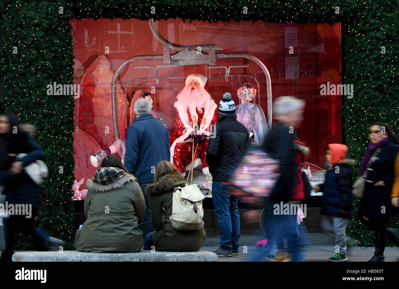 Shoppers outside a Selfridges window display on Oxford Street in London on the first Sunday in December. Stock Photo