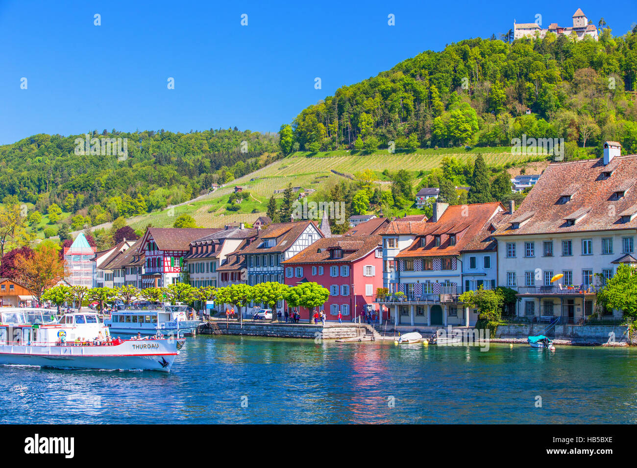 Excursion boat on Rhein river with castle in old city center of Stein am Rhein village with colorful old houses Stock Photo