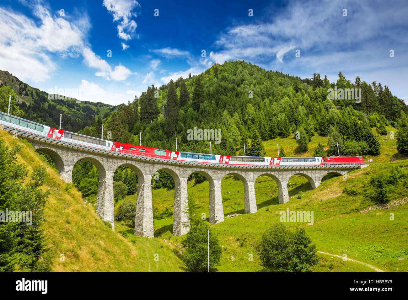 Train on Landwasser viaduct of Rhaetian Railway leading through Swiss Alps near Sankt Moritz Stock Photo