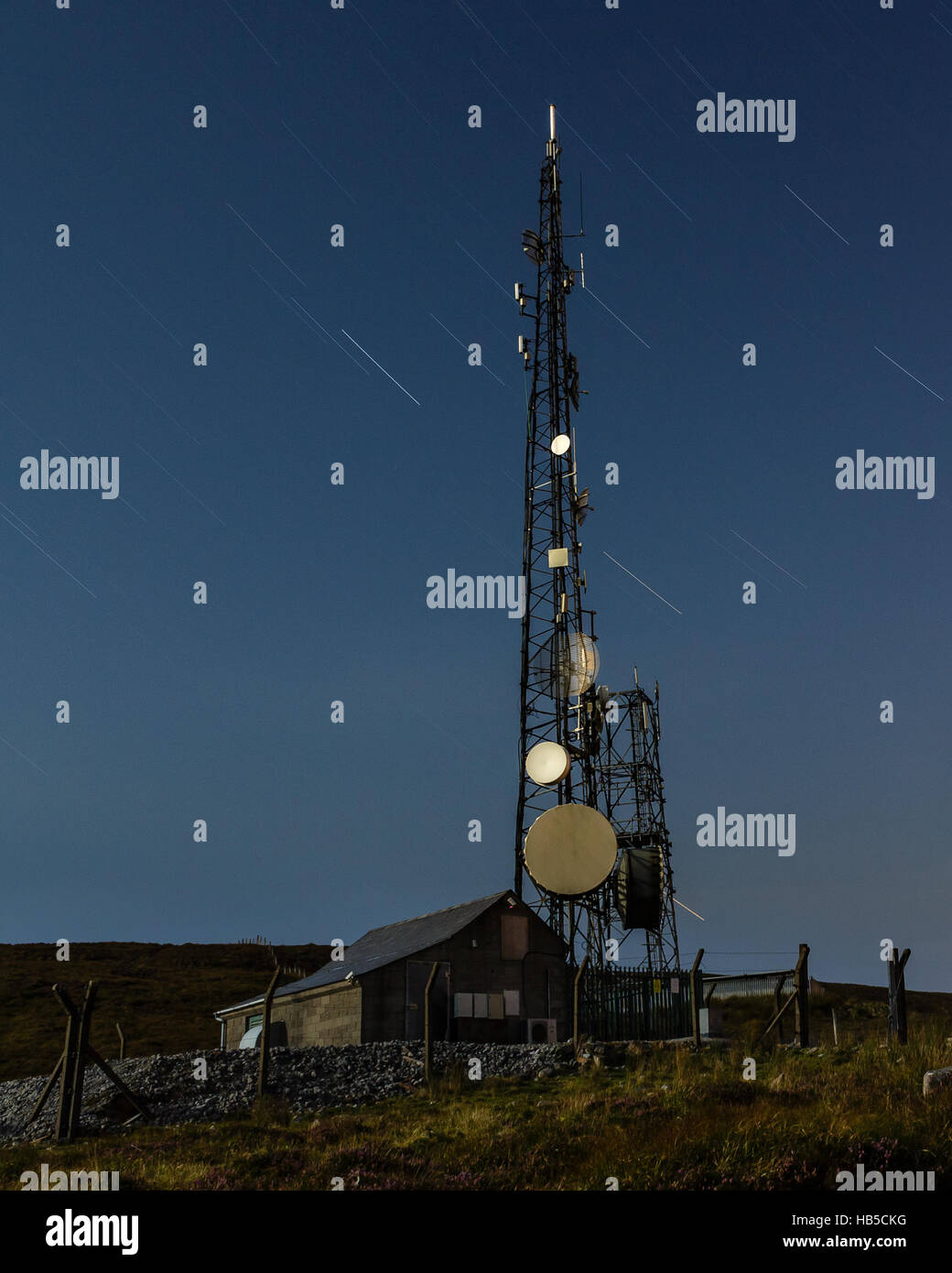 Communication Mast with Star trails at night in County Kerry, Ireland Stock Photo