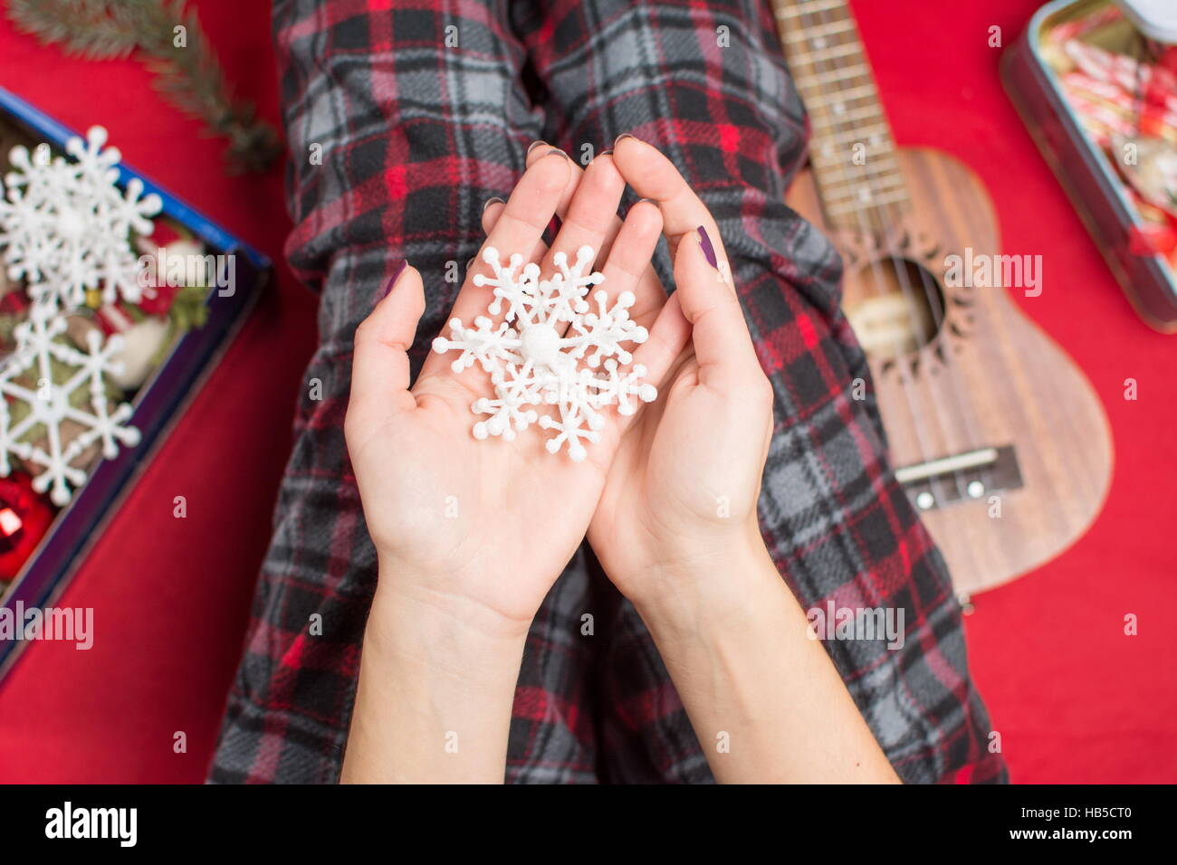 female hands holding an artificial snowflake Stock Photo