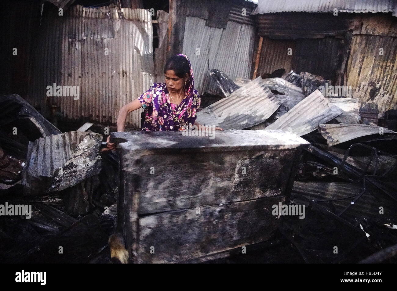 Dhaka, Bangladesh. 04th Dec, 2016. Resident of Korail Slum looks for household from his shanties. A fire broke out at Korail slum, at beside the Gulshan-Banani Lake around 2.50pm. The Fire Service estimates over 500 shanties have burned down in the fire. Credit:  Md. Mehedi Hasan/Pacific Press/Alamy Live News Stock Photo