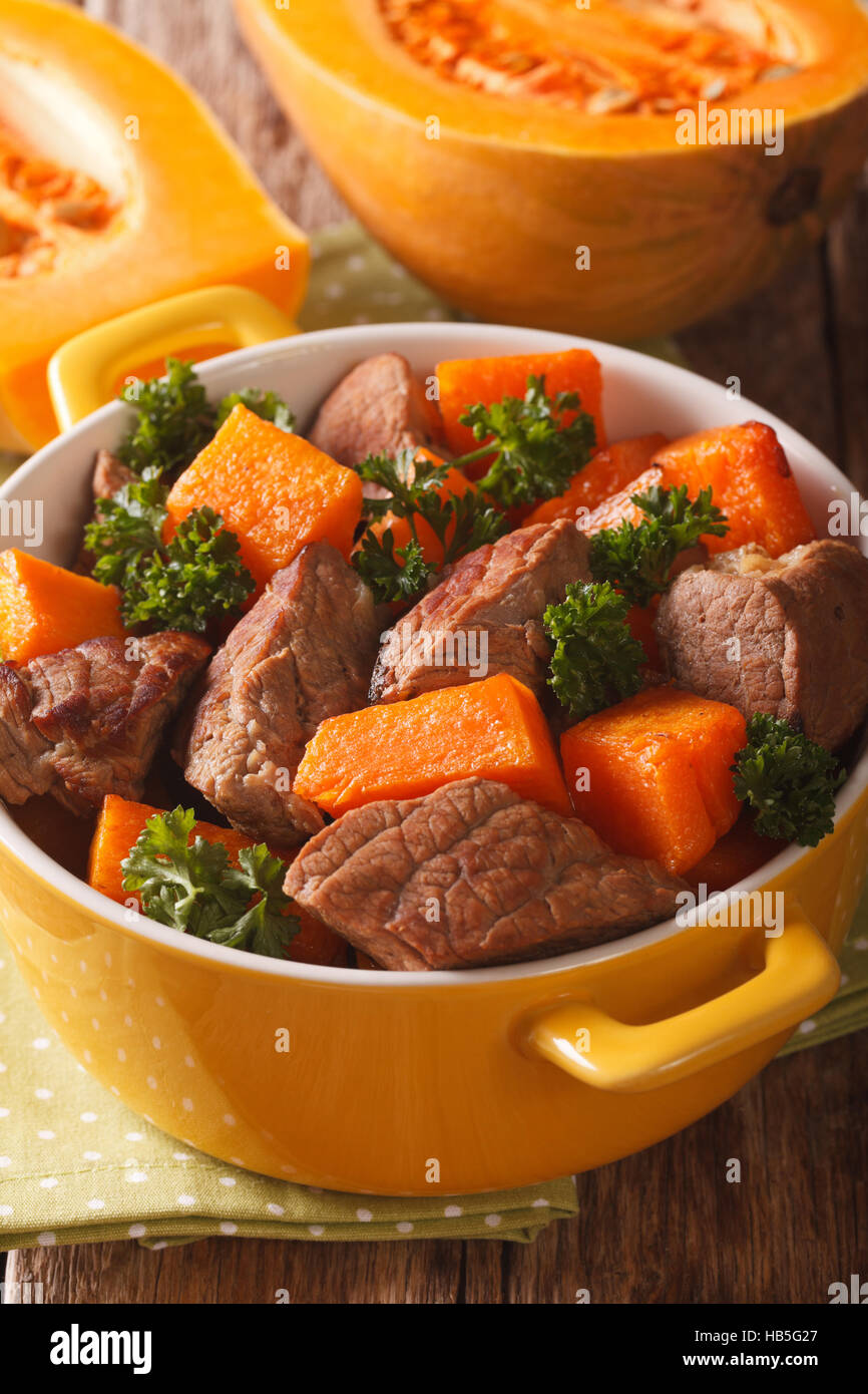 Beef stew with pumpkin macro in a pot on the table. vertical Stock Photo Alamy