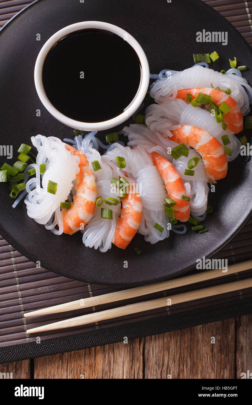 Shirataki with prawns, chives and soy sauce on a plate. vertical view from above Stock Photo