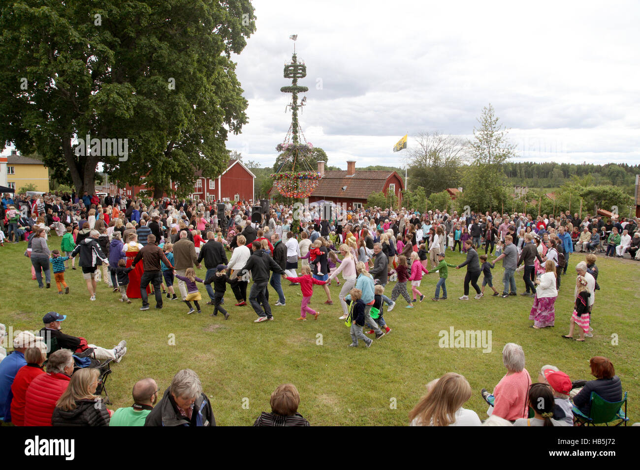 MID SUMMER Celebration at Malmkoping Sweden 2014 people dance around the Maypole Stock Photo