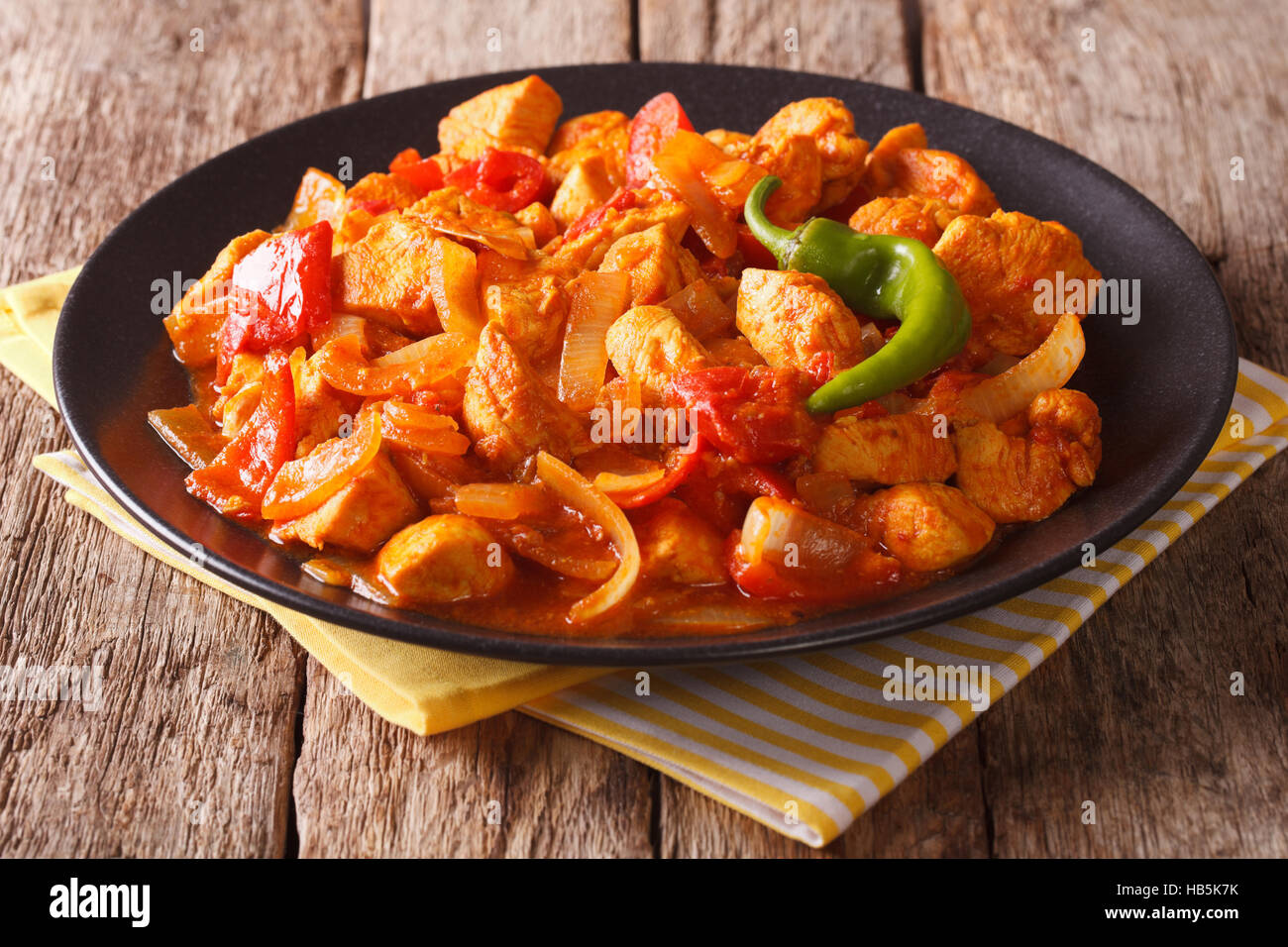 Indian Cuisine: Spicy chicken jalfrezi with pepper and onion close-up on a plate. horizontal Stock Photo