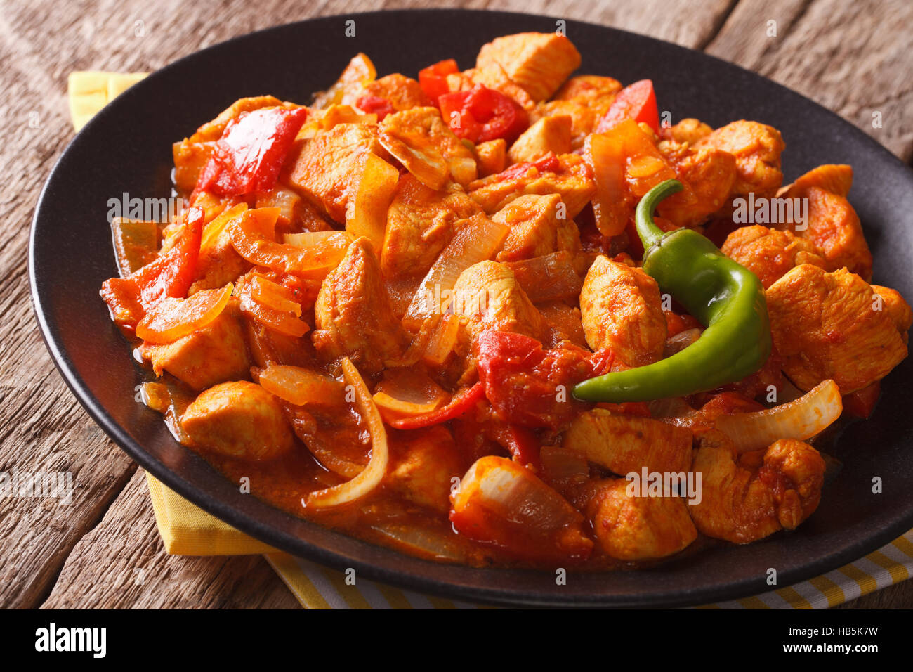 Spicy chicken jalfrezi with pepper and onion close-up on a plate. horizontal Stock Photo
