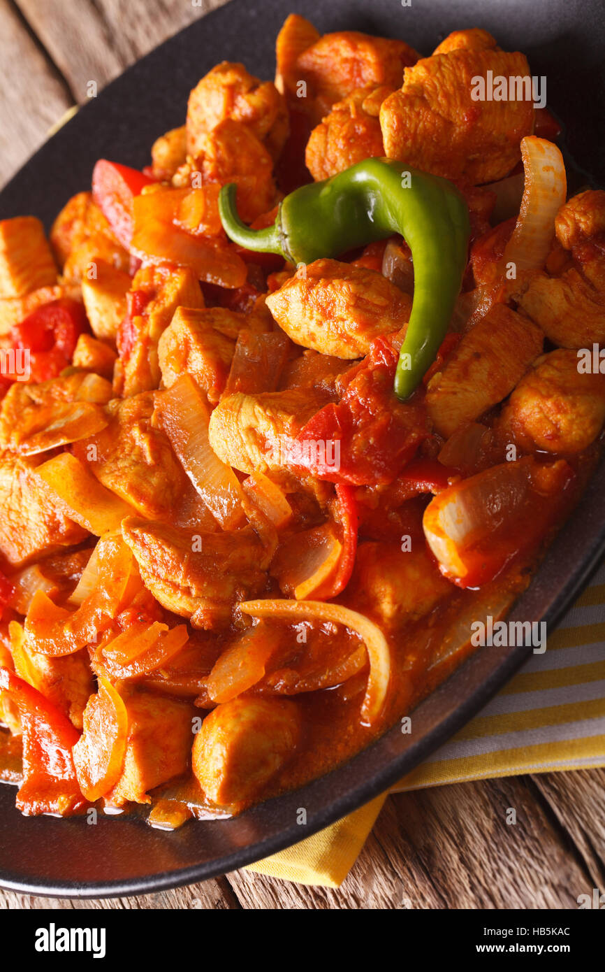 Indian cuisine: chicken Jalfrezi close-up on a plate. vertical, rustic style Stock Photo