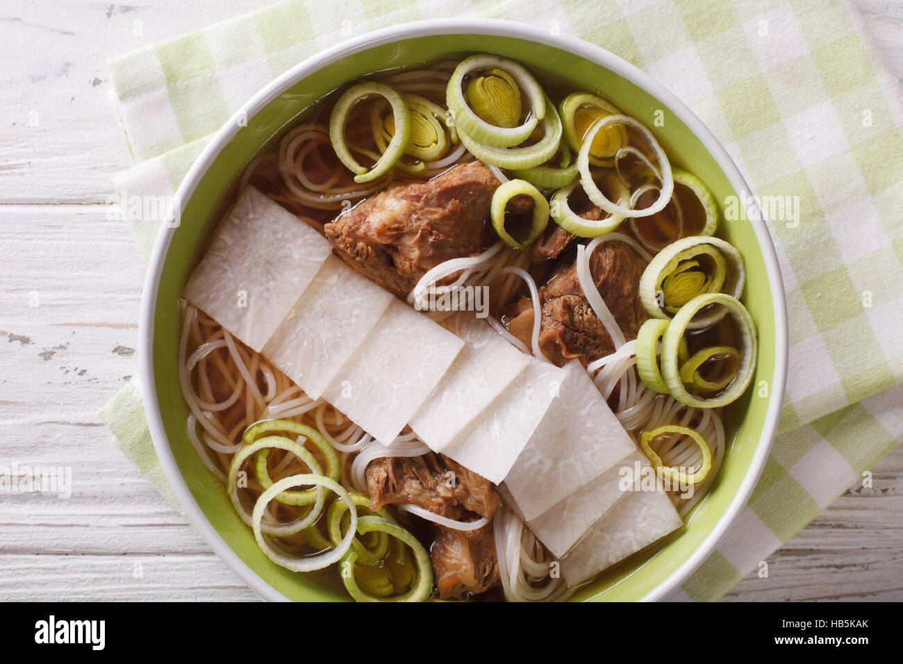 Galbitang Korean soup with beef ribs, rice noodles and daikon close up in a bowl. horizontal view from above Stock Photo