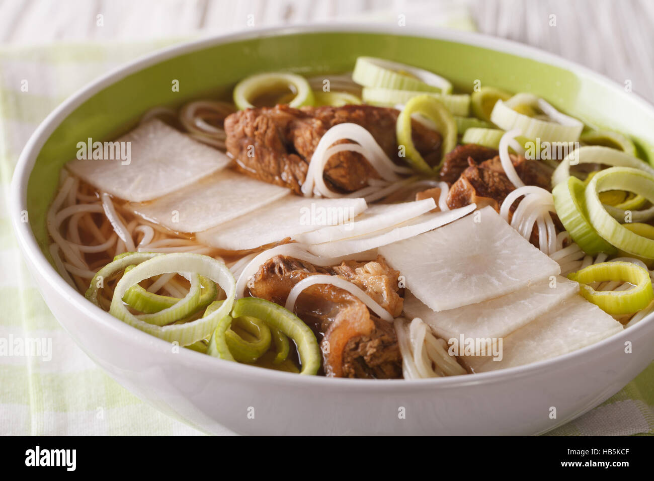 Galbitang Korean soup with beef ribs, rice noodles and daikon close up in a bowl. horizontal Stock Photo